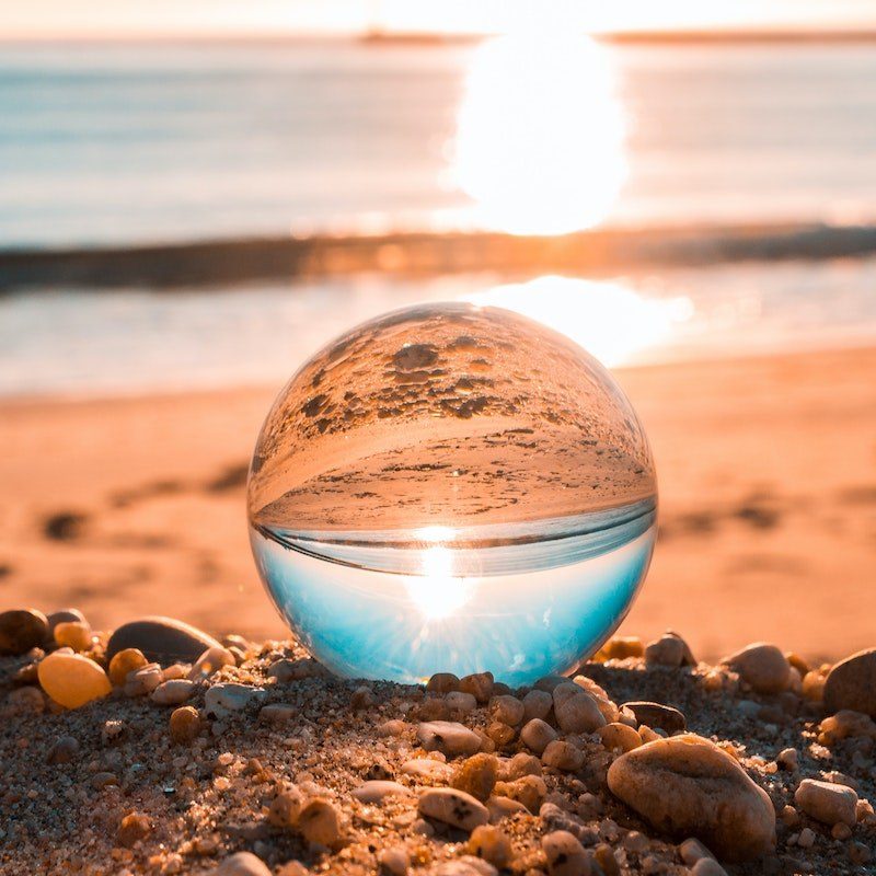Glass sphere on beach